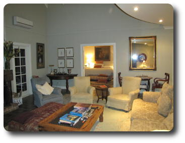 Lounge chairs, coffee table leading to master bedroom