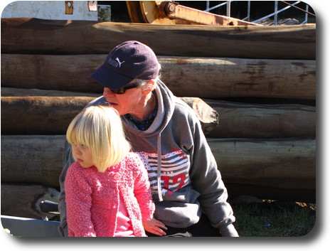 Grandfather and granddaughter looking over their shoulders