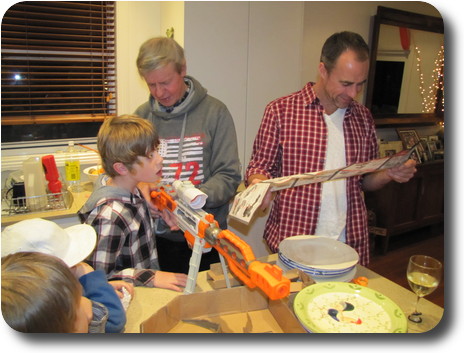 Boy and 2 adults assembling a toy gun