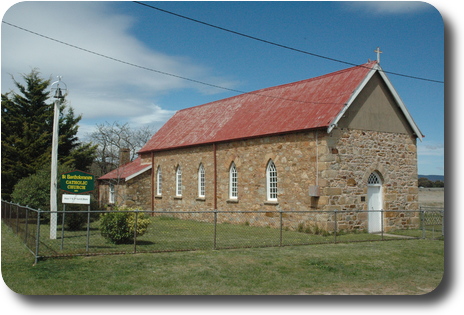 Stone church, red corrugated iron roof, white windows and doorr