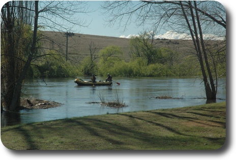 A raft with 2 people coming down the river