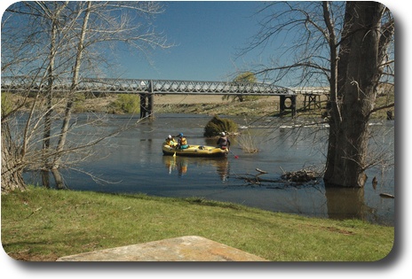 A raft with 2 people coming down the river