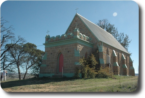 Stone church, metal roof, and castellated vestibule