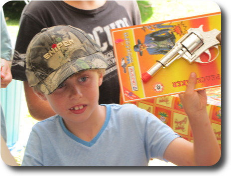 Boy with diecast cap gun and sniper hat