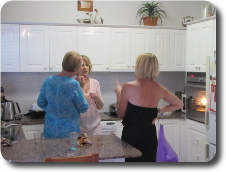 Three ladies in conversation in the kitchen