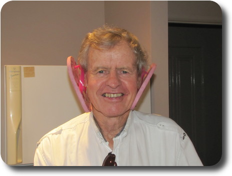 Man with a tiny pink thong hanging from each ear