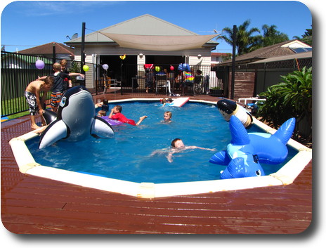 Swimming pool with young children and pool toys