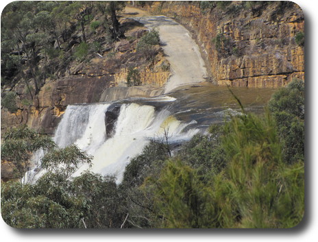 Close up of water cascading over rock face