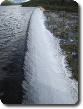 Spillway looks like a small concrete weir, with water flowing over