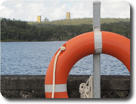 Life presrver (float) on dam wall, with coal mine buildings behind