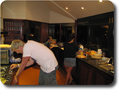 Man, woman boy in kitchen perparing meal