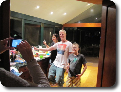 Woman, man and boy in kitchen, facing camera seen on left of photo