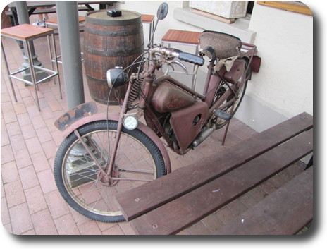 Brownish pink coloured old motorcycle