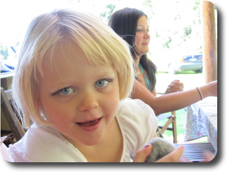 Close up of little girl, without rollers, and woman behind