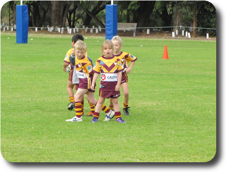 Two little boys and two little girls on the field before the match begins