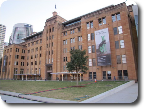 7 storey sandstone building with a lawn in front.