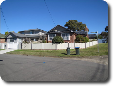 Above house, front view, with neighbouring house, grey wood and tiles