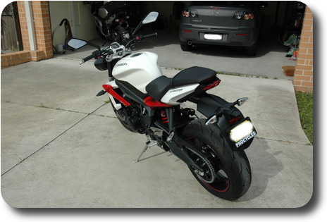 White motorcycle - from left rear