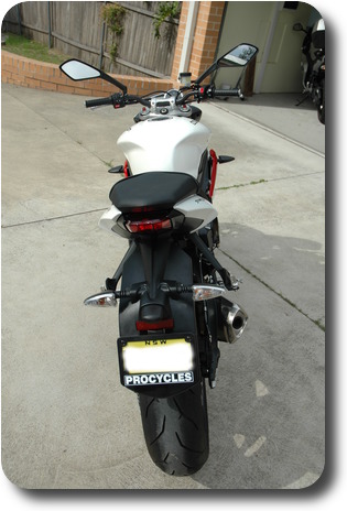 White motorcycle - from rear