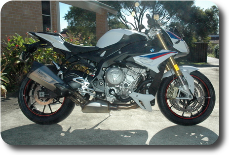 Right side view of white, blue red motorcycle, black frame