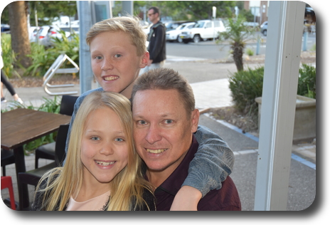 Glenn, Cooper and Lily at restaurant table