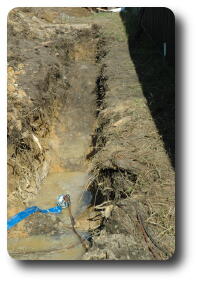 Trench with some water and pump