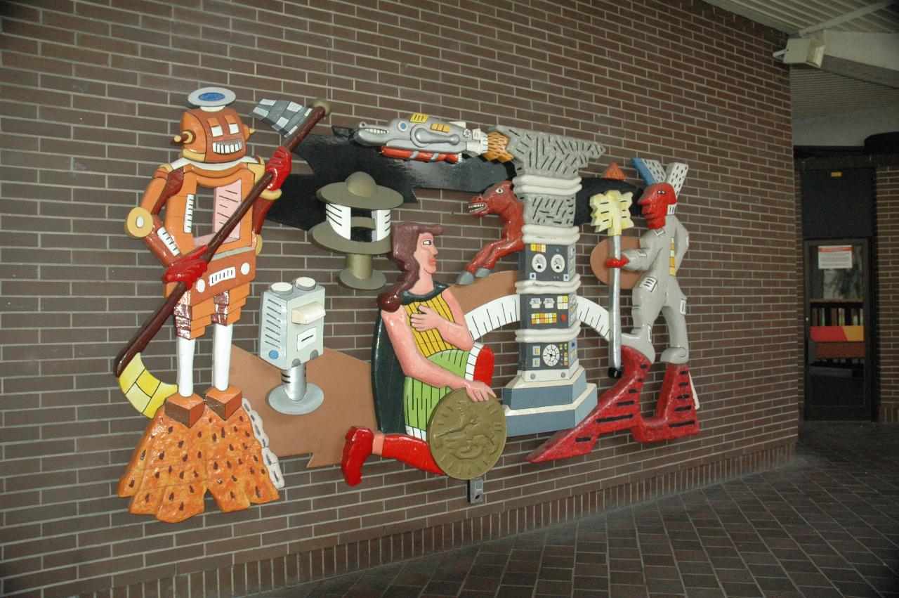 Colorful relief sculpture on brown brick wall