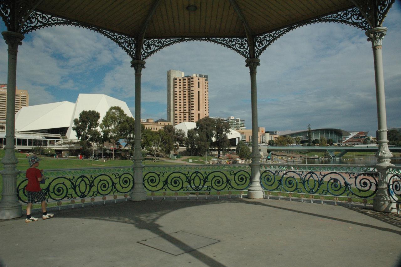 View through rotunda over grassy park to city buildings behind