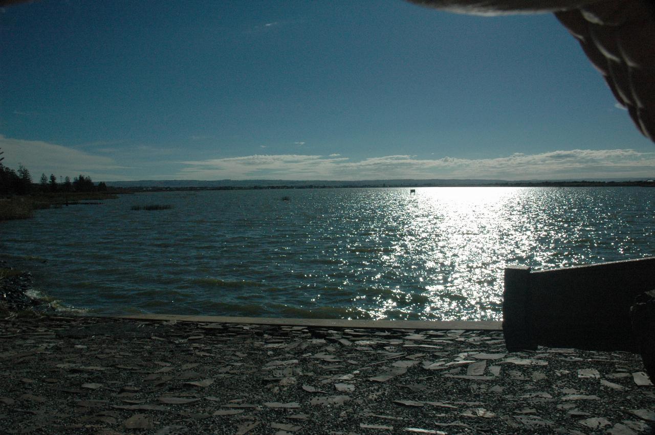 Sun reflecting off water, looking to very distant town of Goolwa
