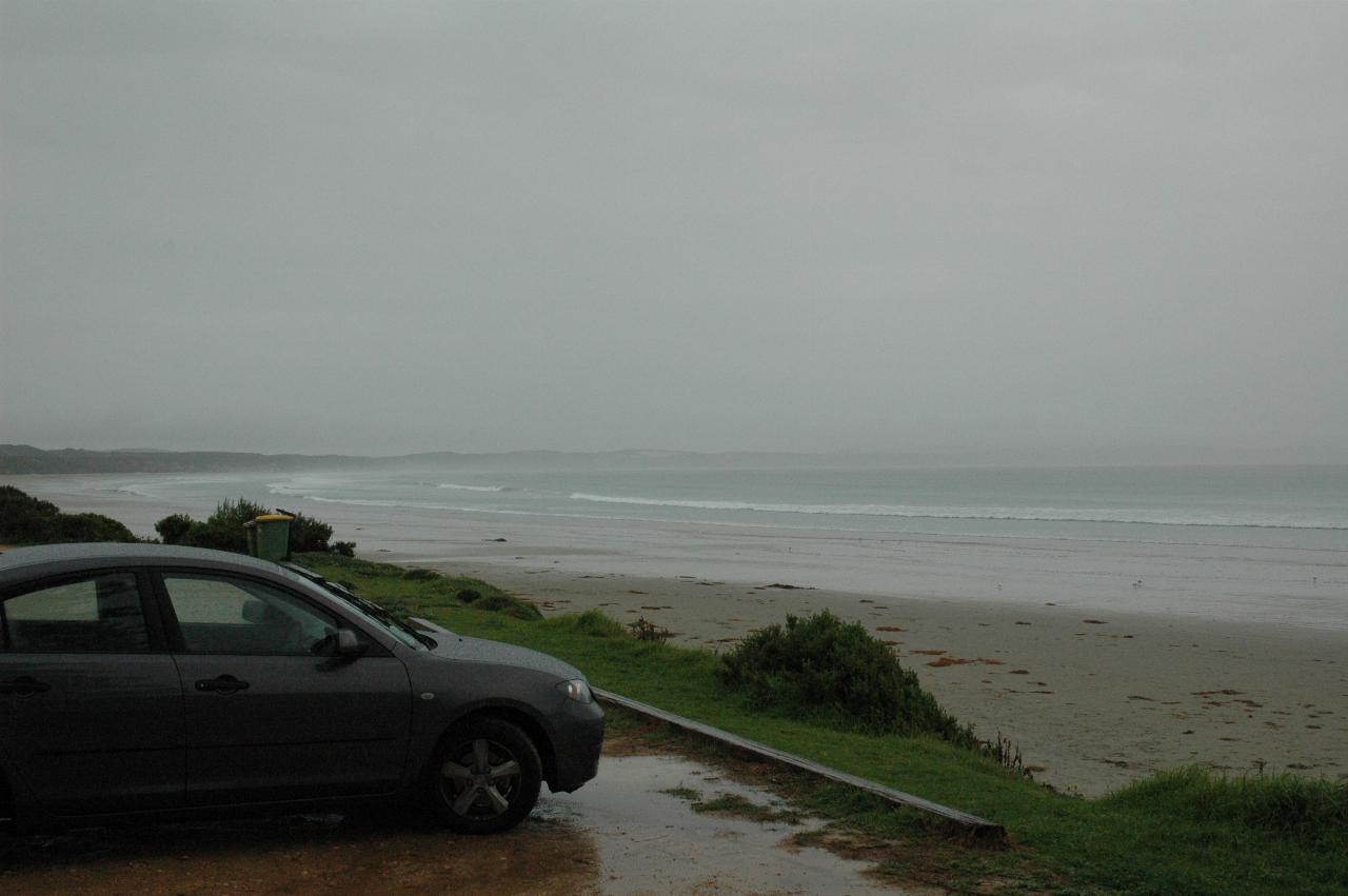 Car park, beach, ocean and shoreline disappearing into the gloom