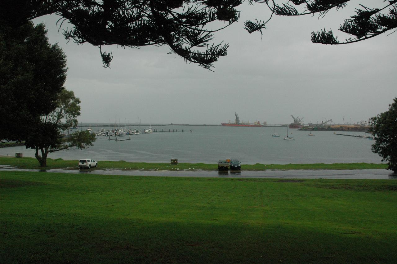 Grassy area in front, harbour with distant boats and wharves