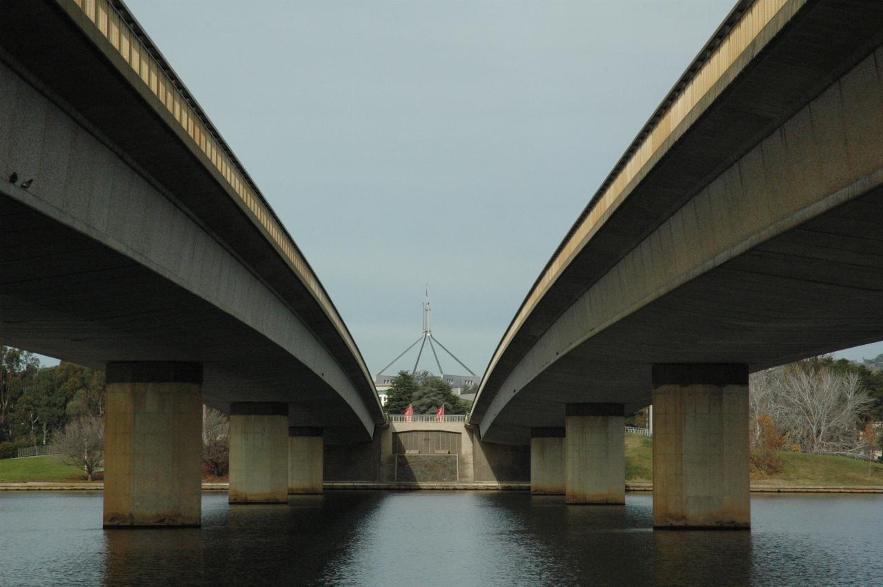 Between parallel bridges with giant flag pole in distance between the bridge decks