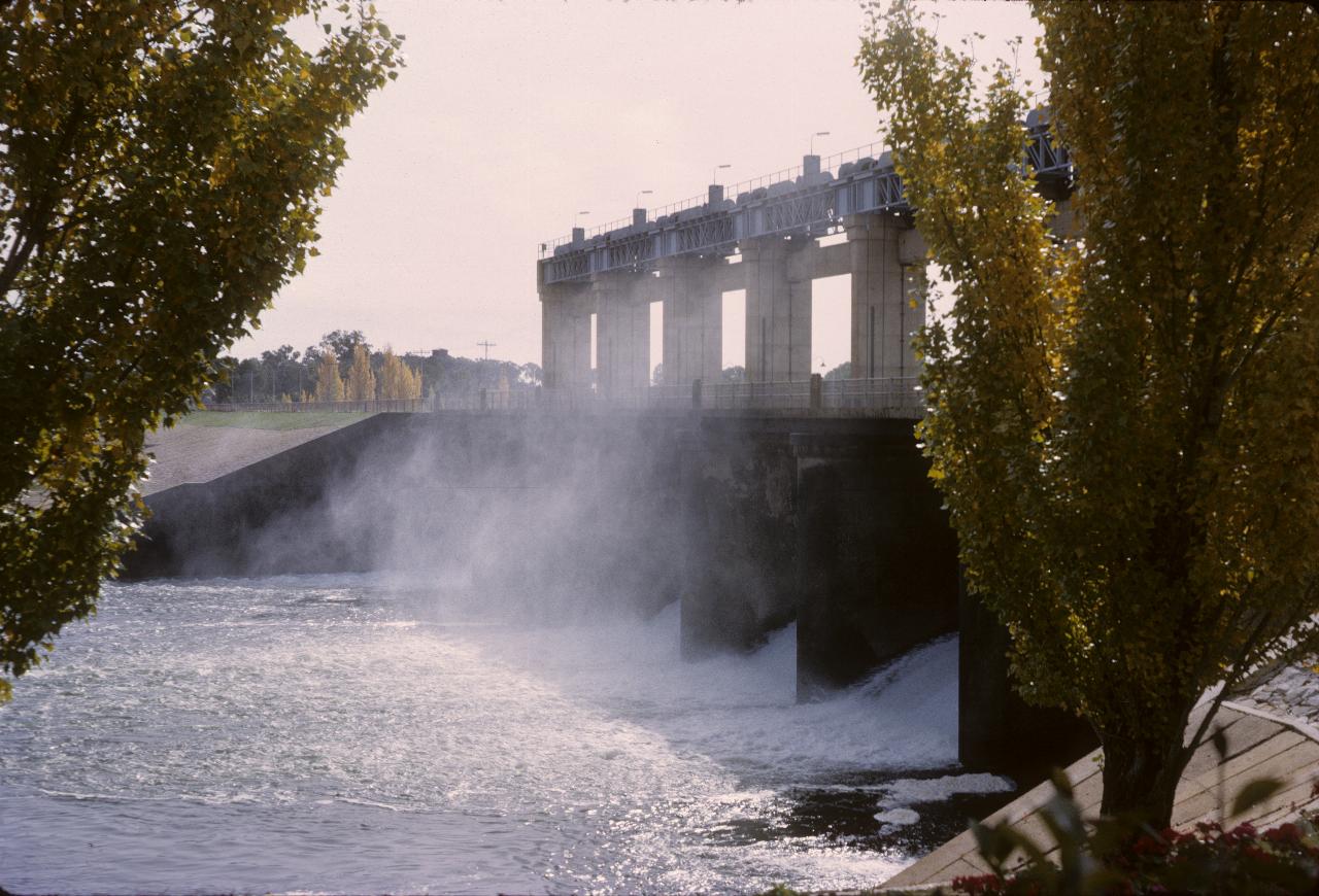 Low dam with spillways in action, at a low rate
