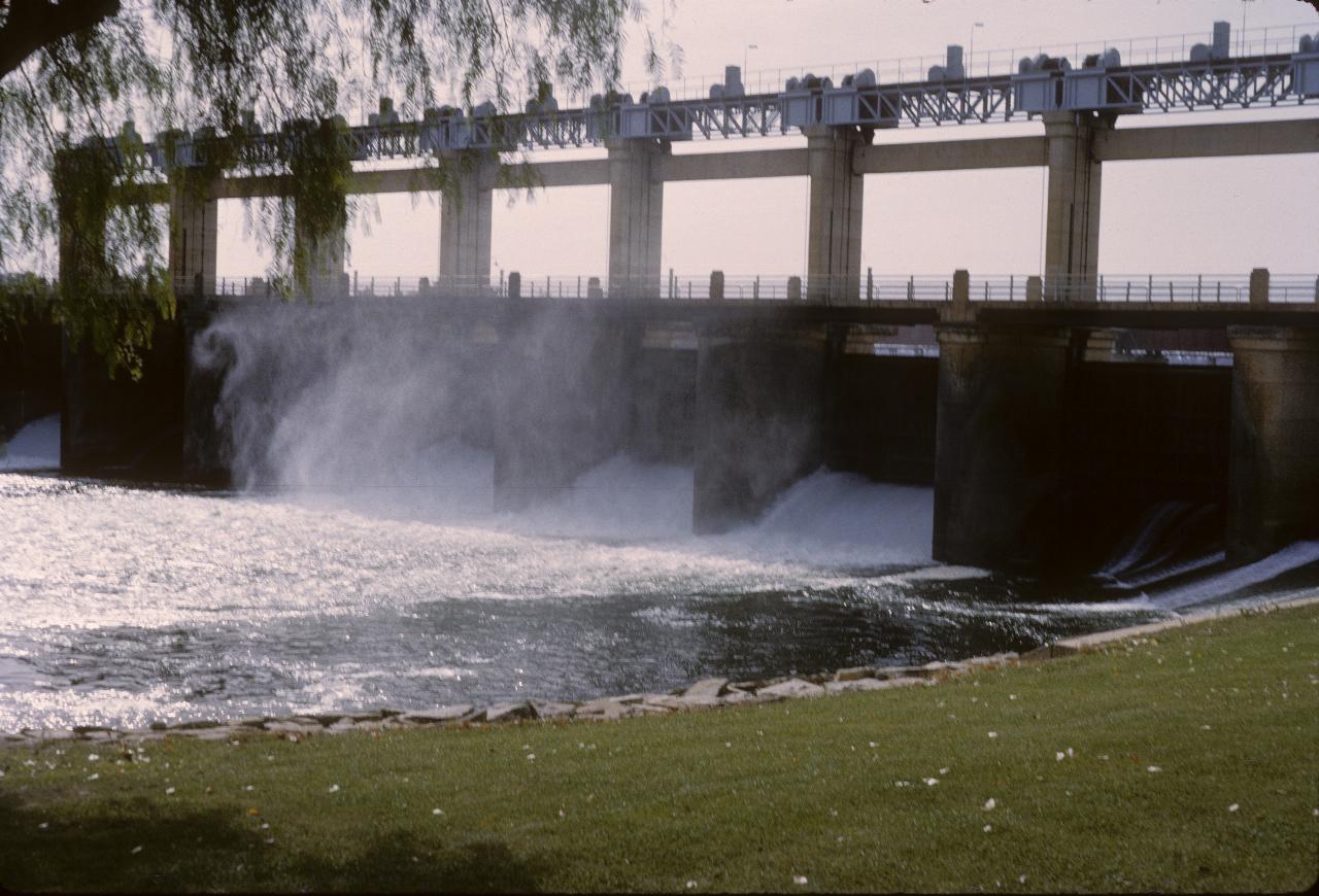 Low dam with spillways in action, at a low rate