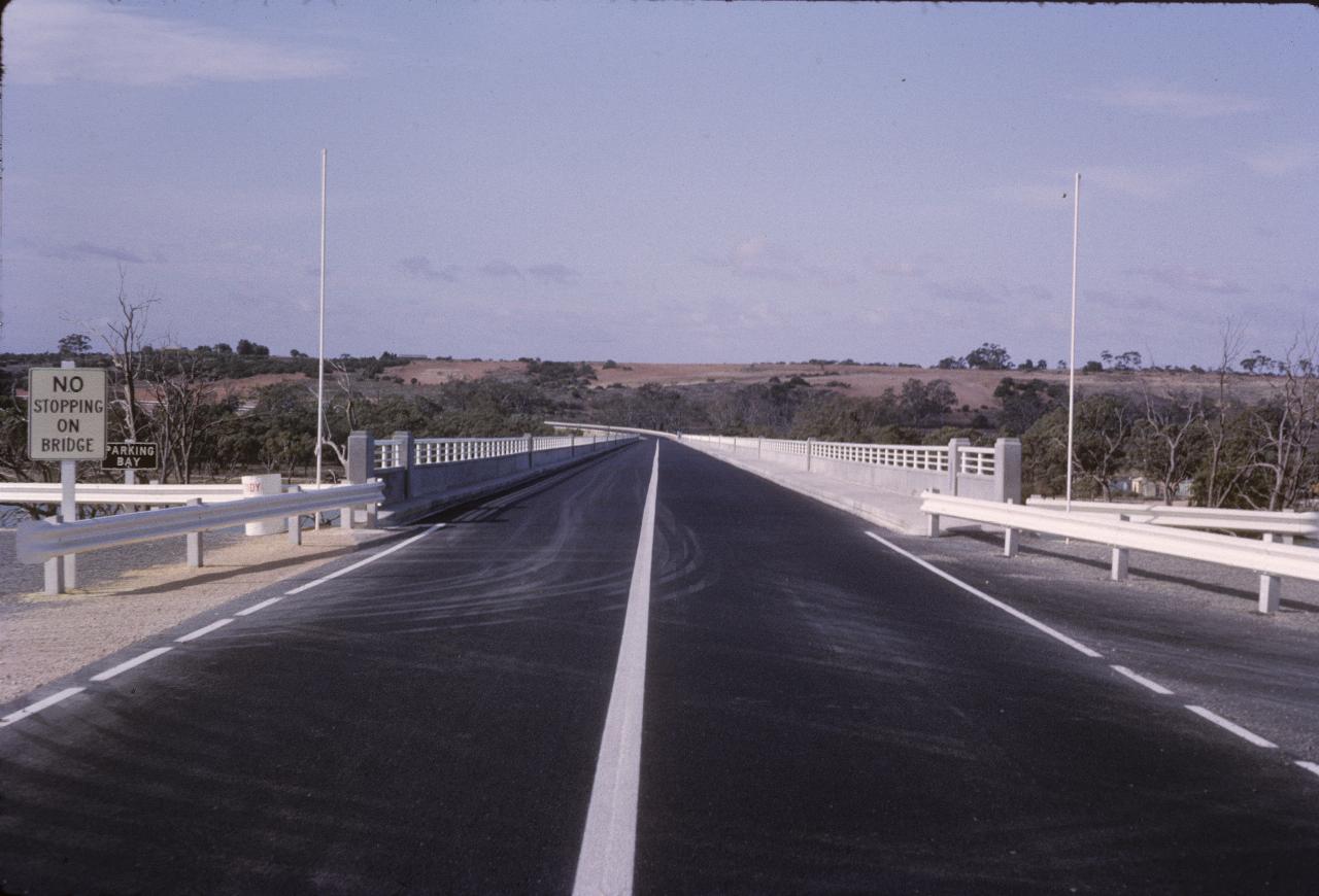 Looking down road with new surface over brand new bridge