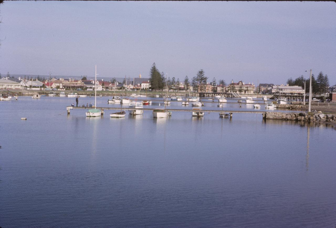 Small boats anchored in calm waters of small bay