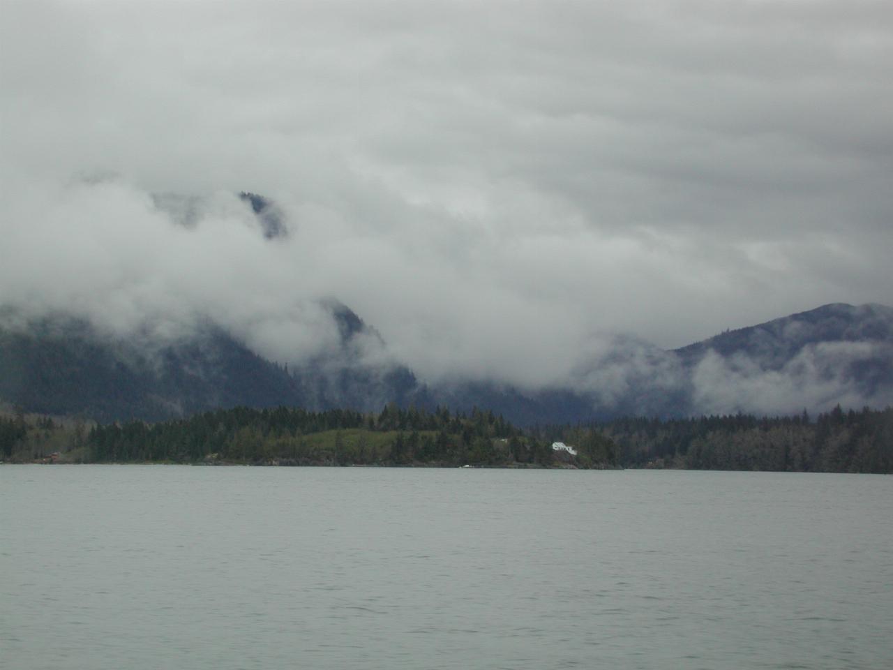 An isolated house, surrounded by low clouds