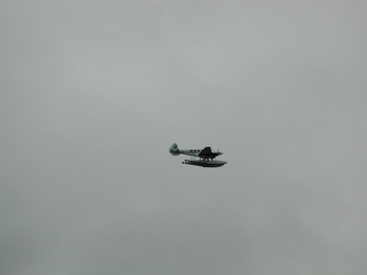 The float plane with the parts to fix the disabled boat's fuel pump