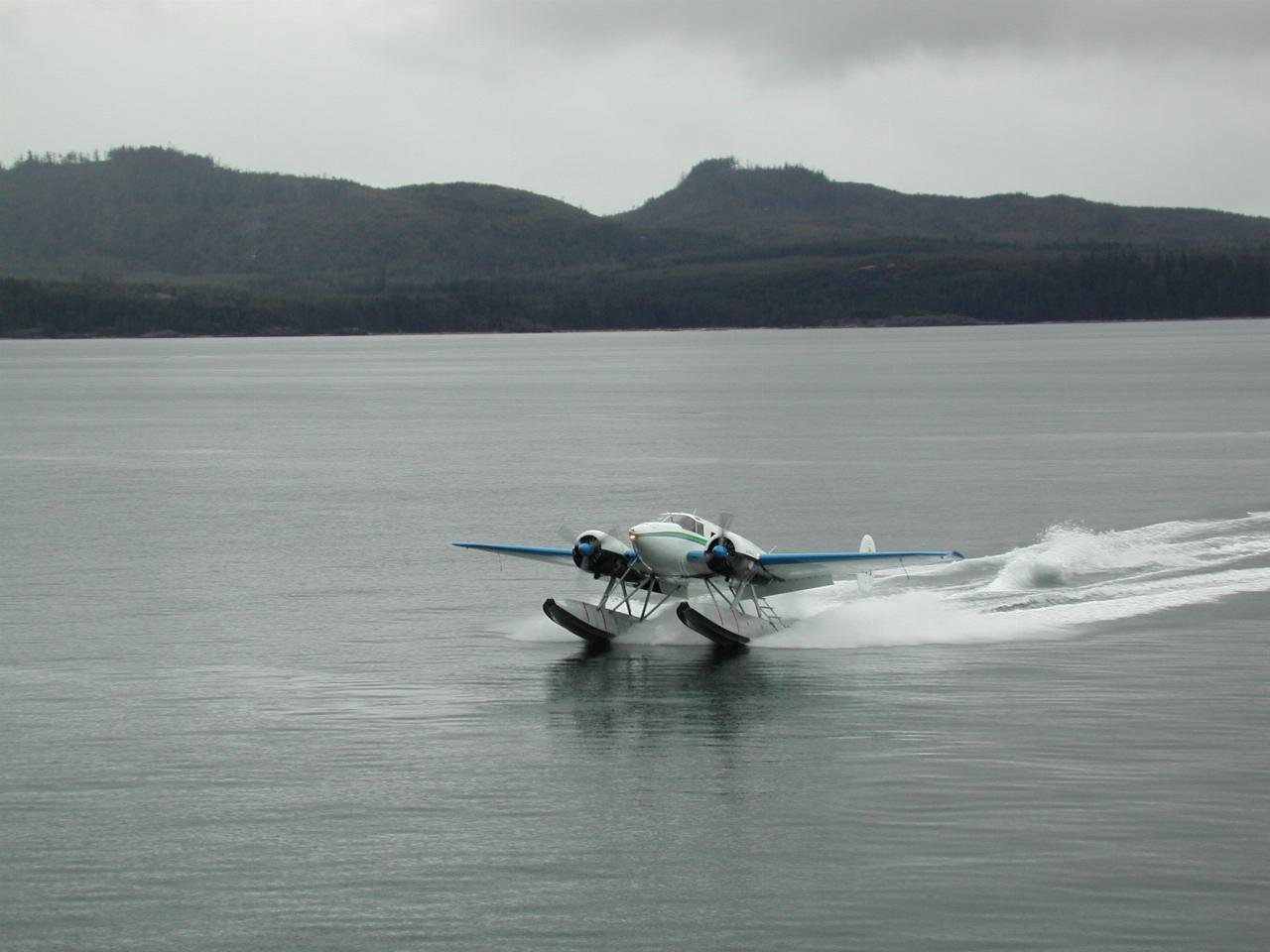 The float plane with the parts to fix the disabled boat's fuel pump