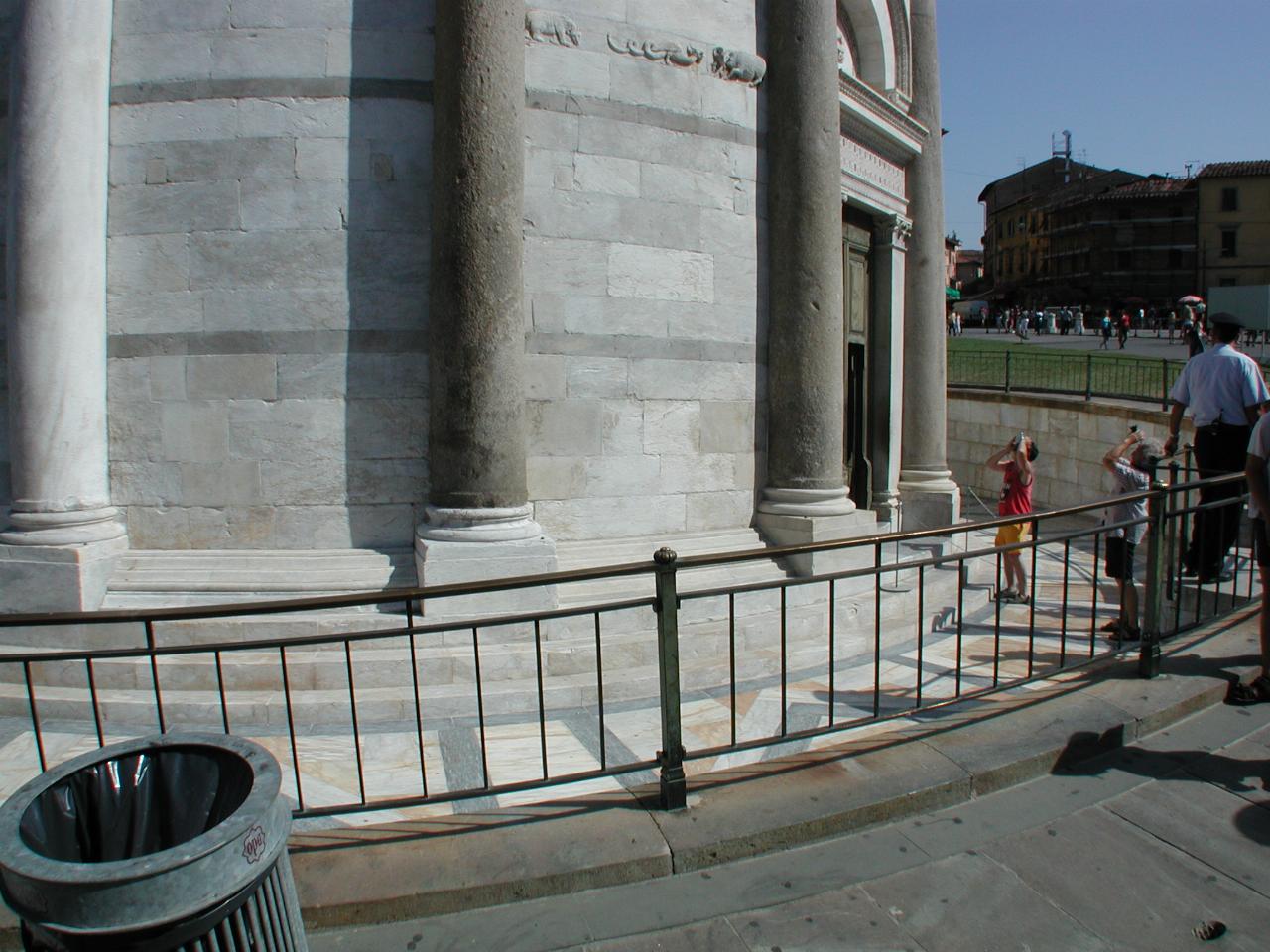 The base of the leaning tower of Pisa, showing degree of sinkage on far side