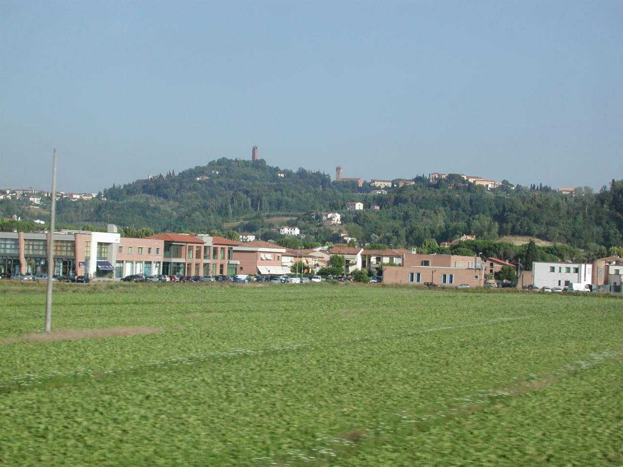 View from bus on way from Pisa back to Florence, showing towers and hill towns