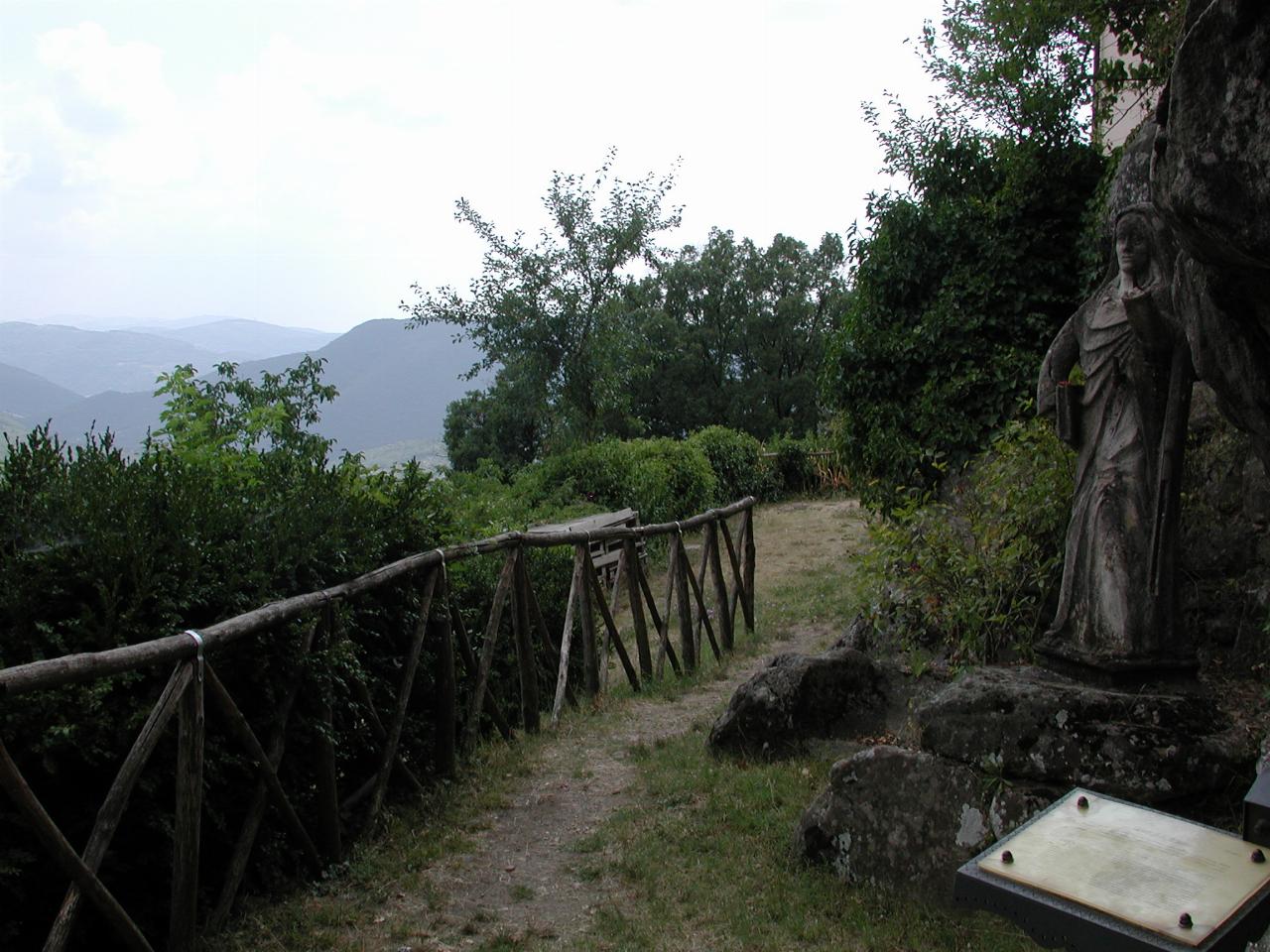 View over the hills from St. Brigid's cave, with statue of St. Brigid on far right
