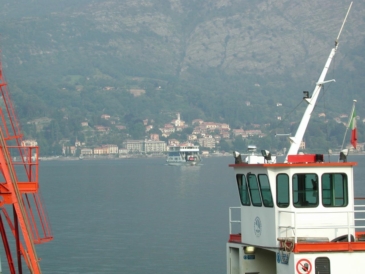 Car and passenger ferry crossing Lake Como towards Bellagio