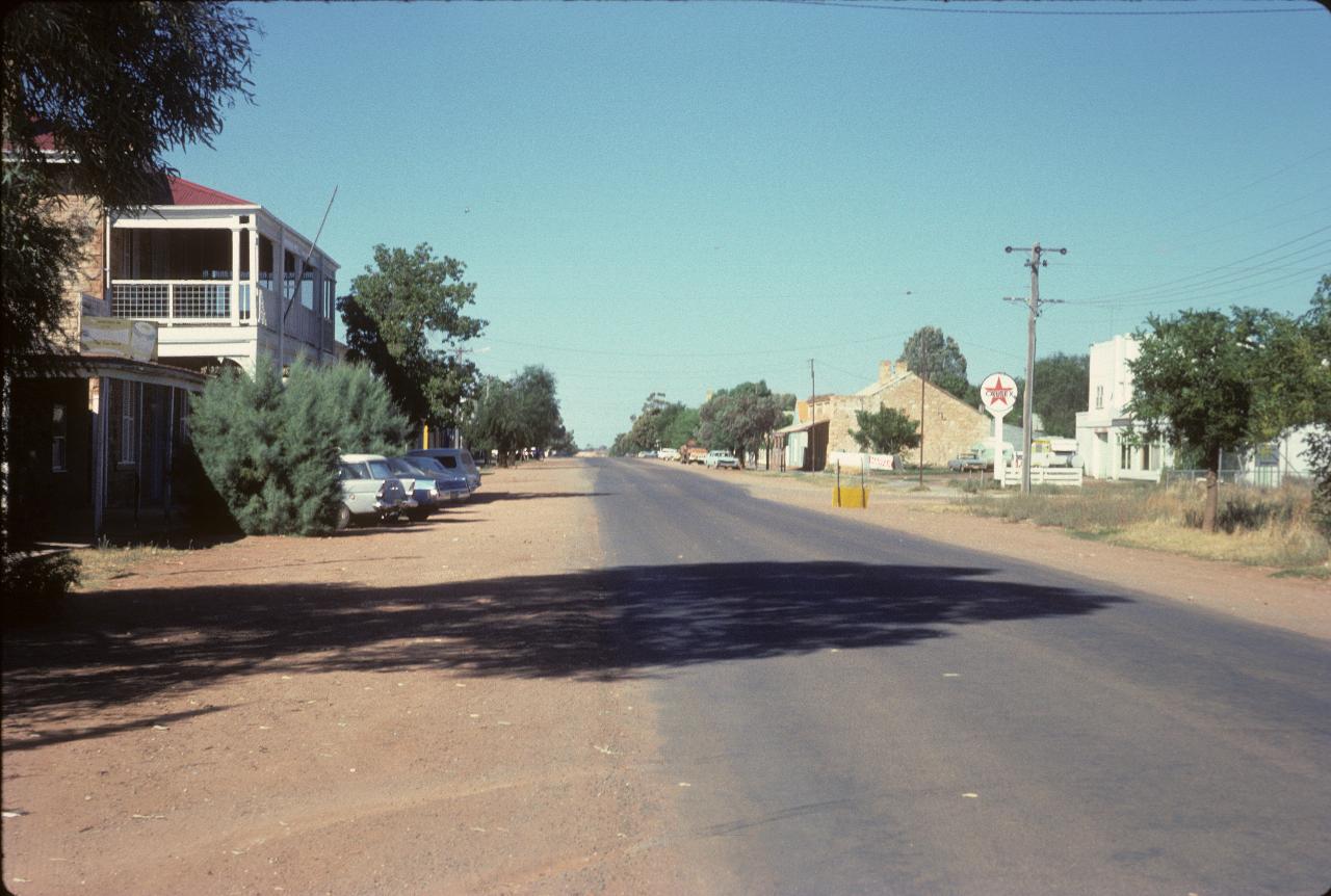 2 lane road, dirt edges and a few commercial buildings