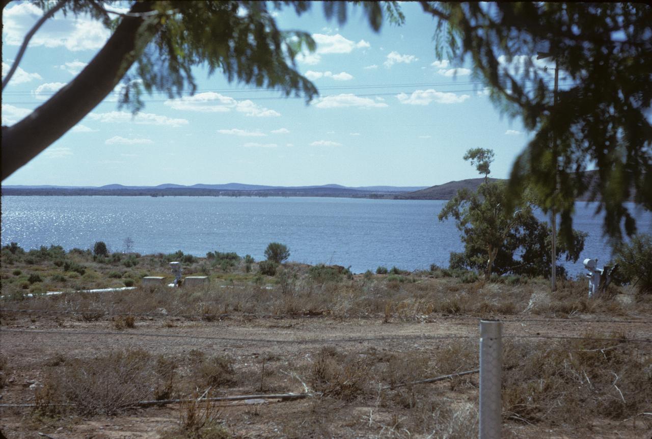 Large lake, with distant hills and nearby trees