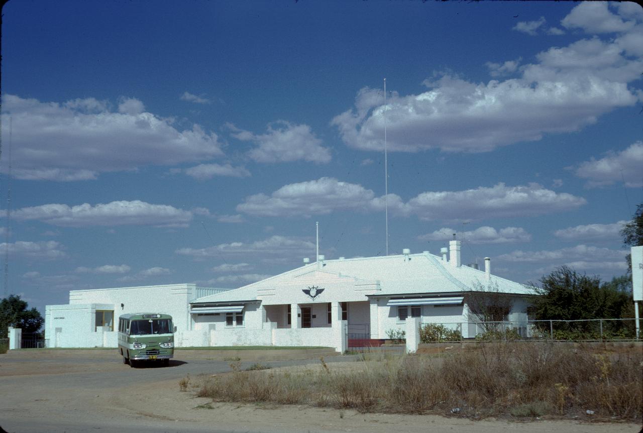 Single storey white building with several radio towers