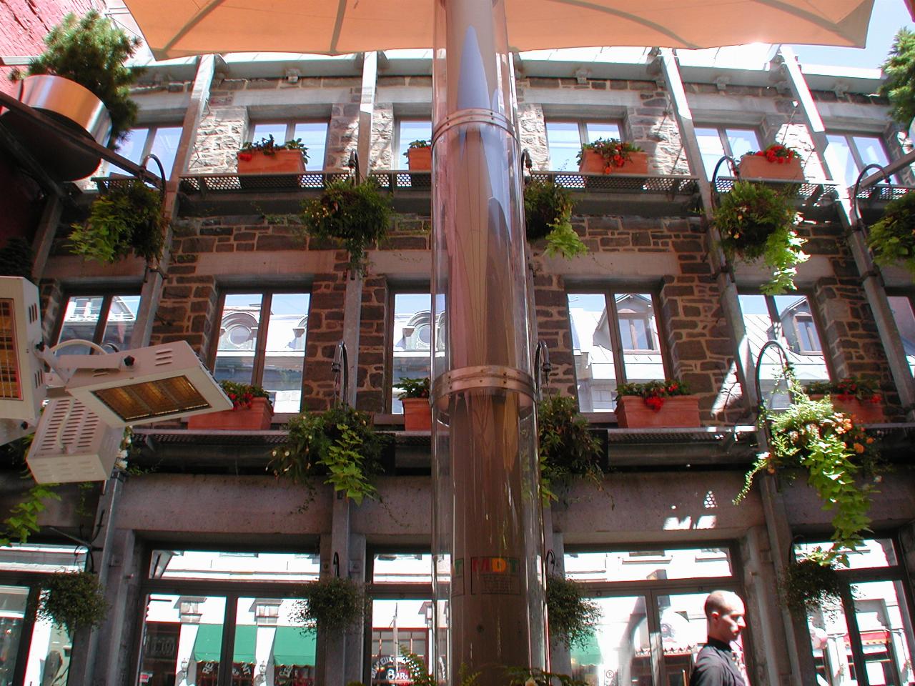 An outdoor restaurant, but with an old building wall, utilised in a botanical manner