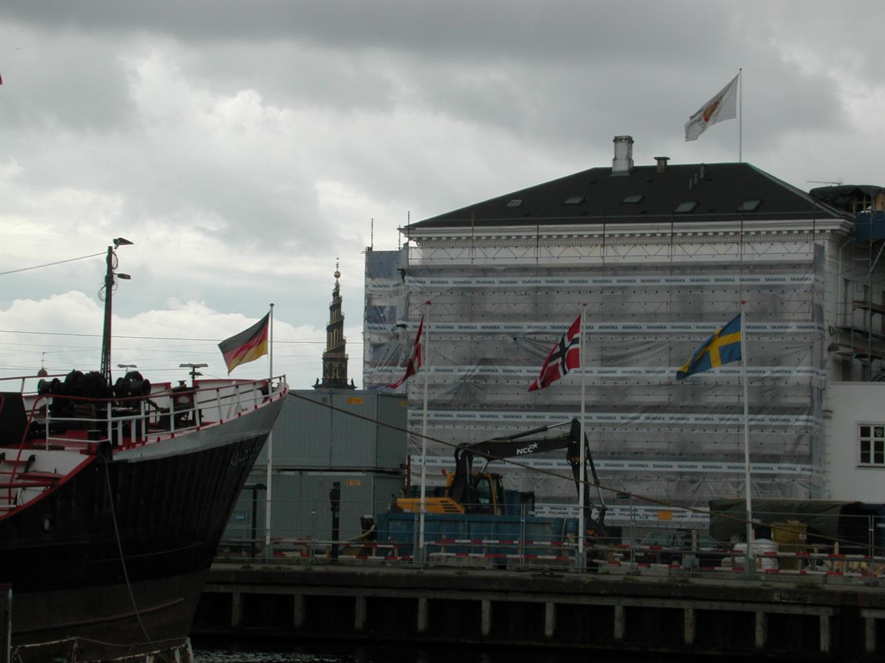 KPLU Viking Jazz: German, Danish, Norwegian and Swedish flags at wharf, with Our Saviour Church [Von Frelsers Kirken] spire in the background